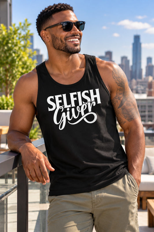 Smiling man in a black Selfish Giver unisex tank with white lettering on a city rooftop